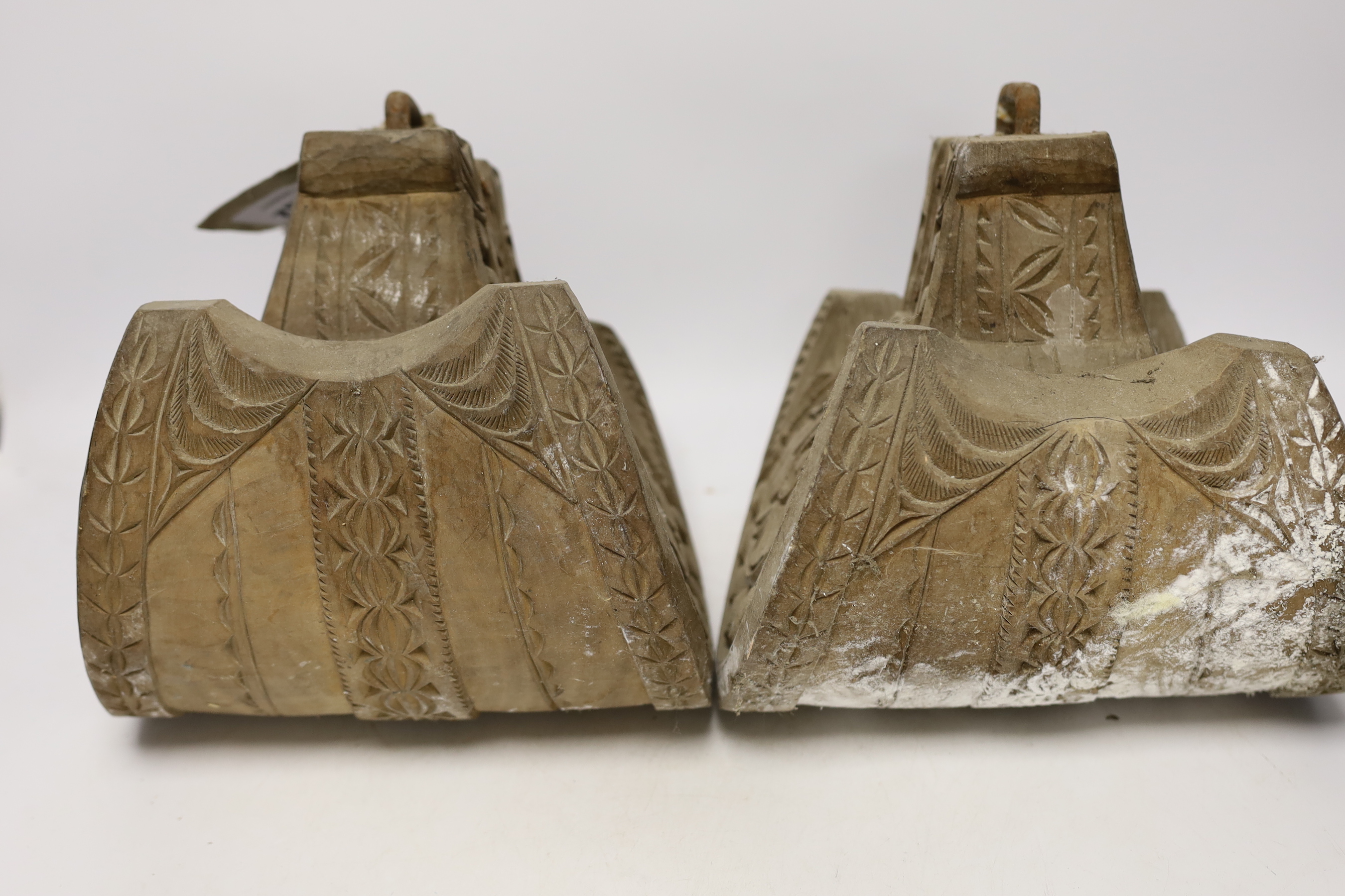 A pair of Spanish-Colonnial carved wood stirrups and a pair of Indian leather shoes